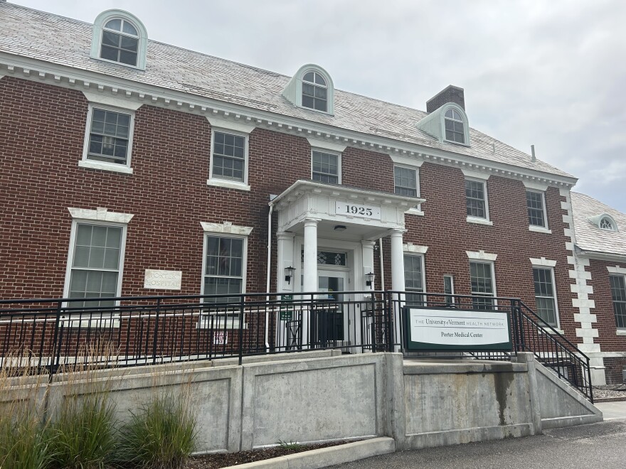 A red brick building with a black railing and a white sign that says "Porter Medical Center"